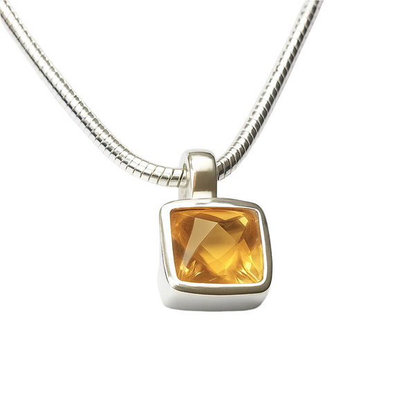 Silver necklace with a citrine gemstone pendant on a white background