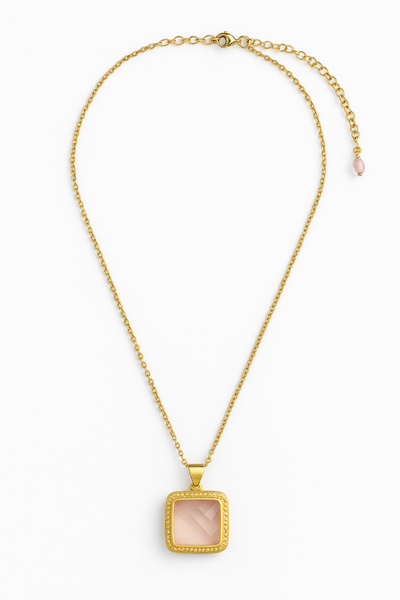 Gold necklace with a square pendant on a white background