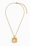 Gold necklace with a square pendant on a white background